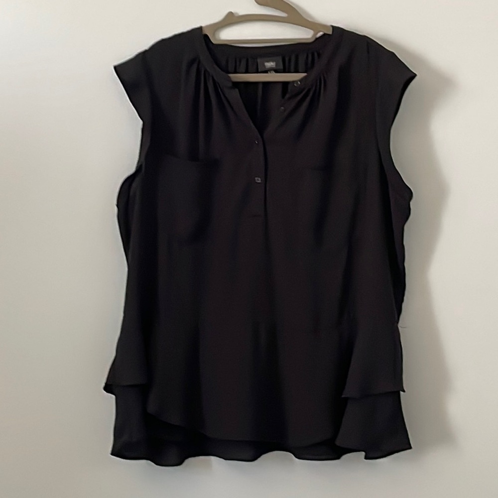 Lightweight sleeveless top with ruffled bottom.
